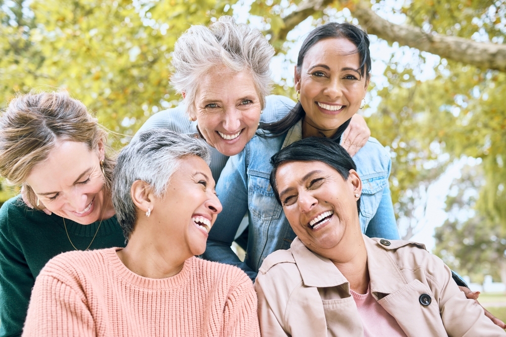 group of mature women laughing outdoors