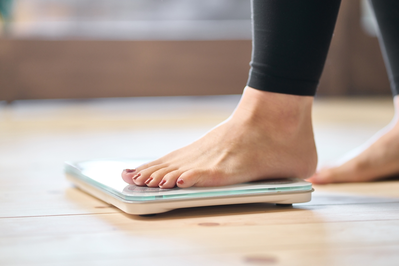 woman's foot stepping on floor scale