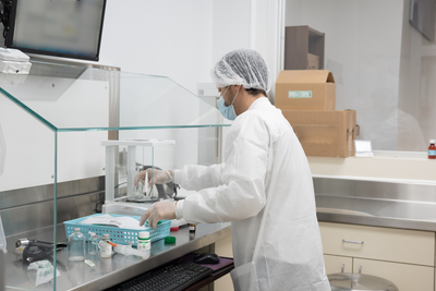 pharmacist mixing ingredients in lab