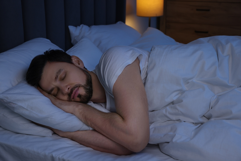 man sleeping in dark room