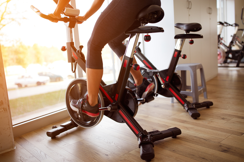 woman using stationary bike at gym