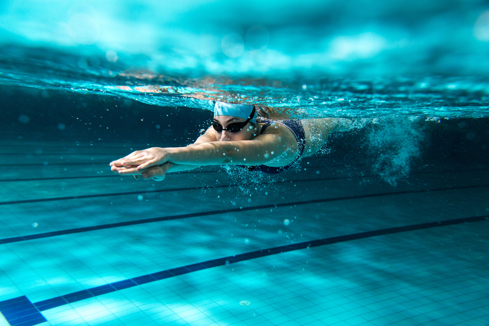 woman swimming laps in pool