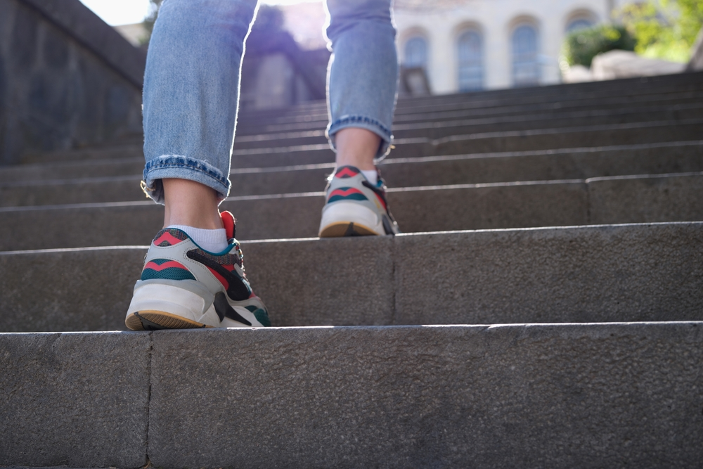 sneaker-clad feet walking up stairs