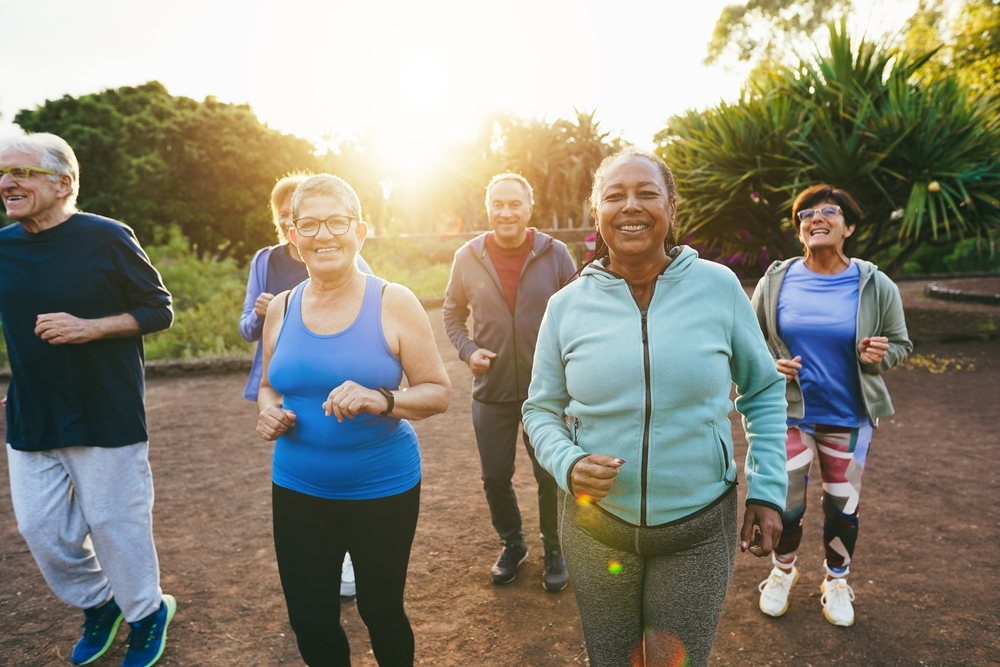 group of smiling seniors exercising together