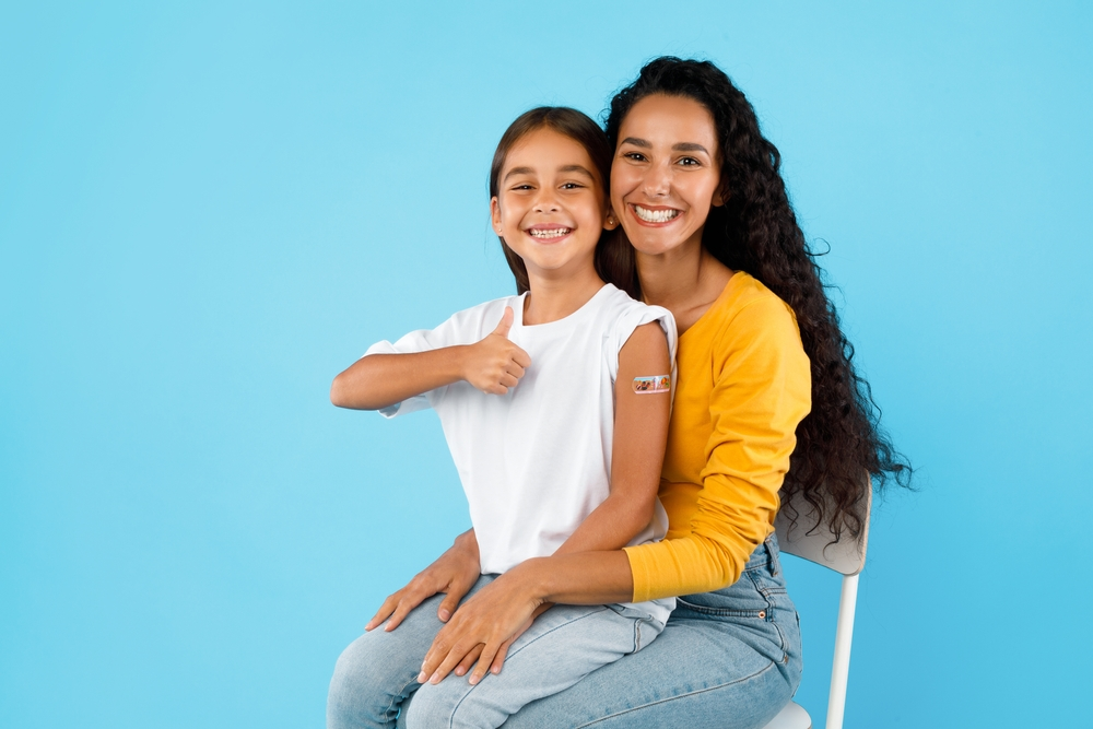 mom and daughter smiling after immunizations