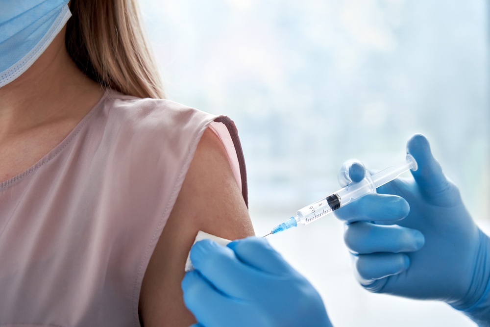 woman receiving immunization shot