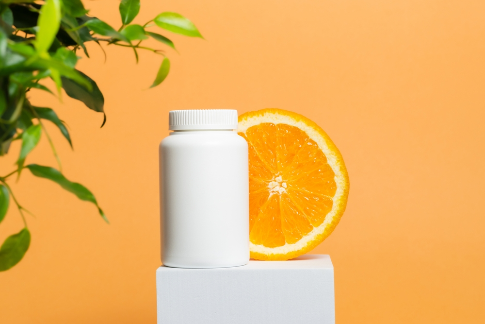 white vitamin bottle with orange slice